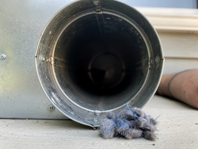 Coral Springs Dryer Vent Cleaning technician using specialized equipment to clear severe dryer vent blockage in Coral Springs
